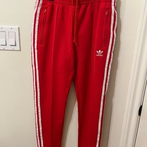 Red adidas track pants